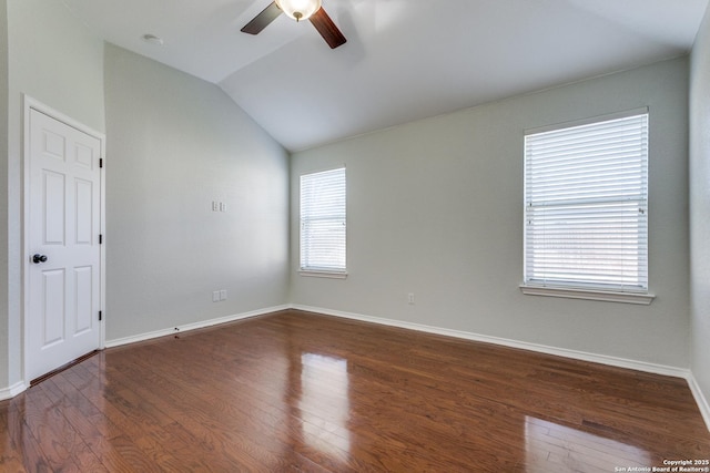 spare room with lofted ceiling, dark wood-type flooring, and ceiling fan