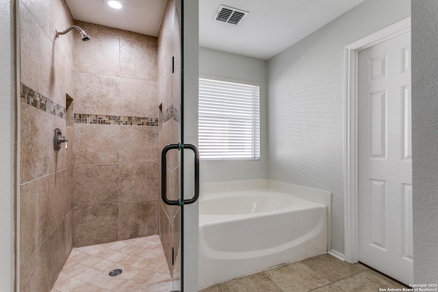 bathroom with independent shower and bath and tile patterned floors