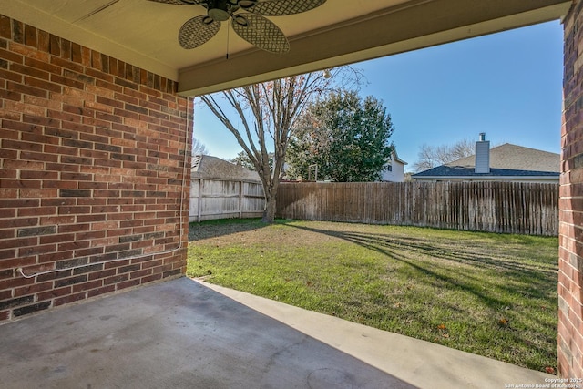 view of yard with a patio area and ceiling fan