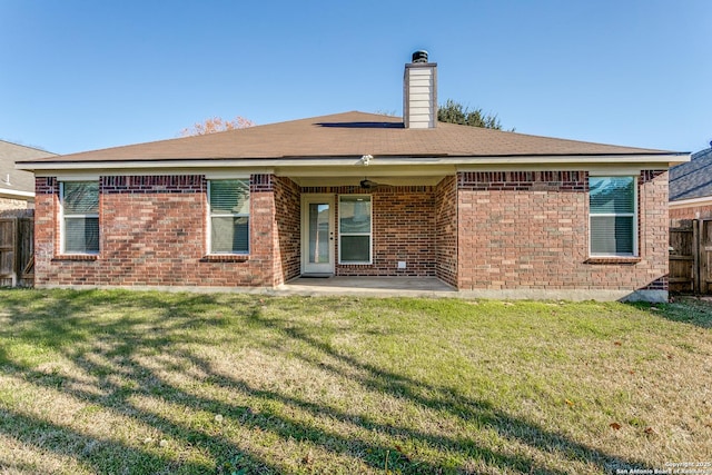 back of house featuring a yard, a patio, and ceiling fan