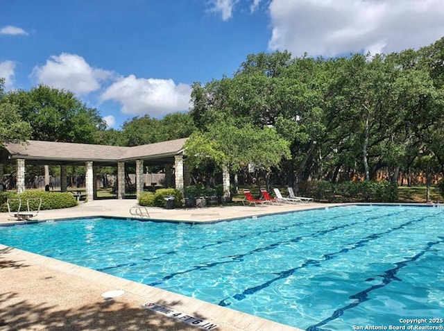 14119 Silver Charm, San Antonio, TX 78248 - community pool with view of wooded area and a patio area