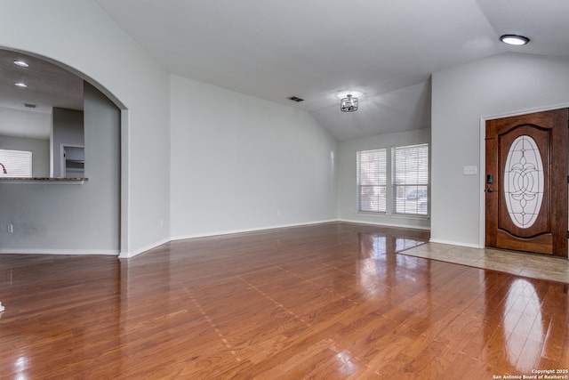 entryway with lofted ceiling and hardwood / wood-style flooring