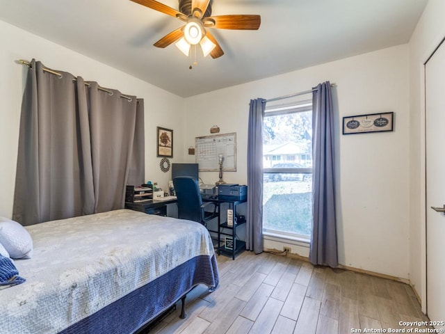 bedroom with ceiling fan and light hardwood / wood-style floors