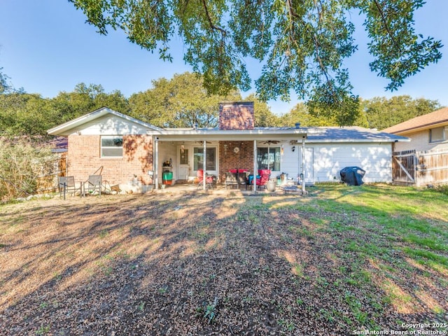 back of property with a yard, a patio, and ceiling fan