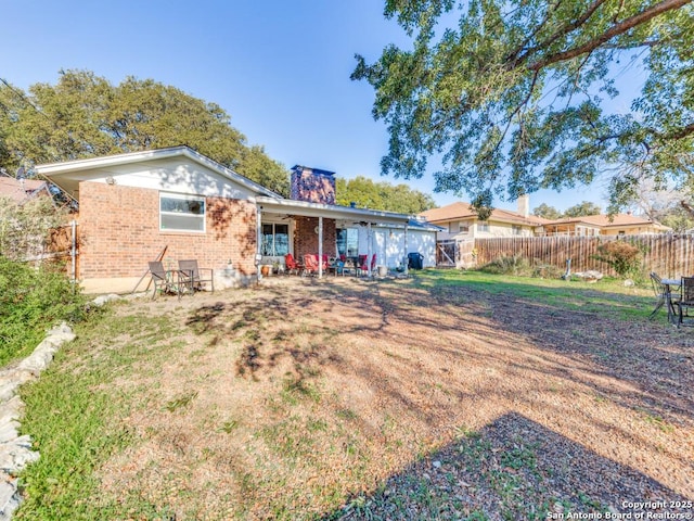 rear view of house with a yard