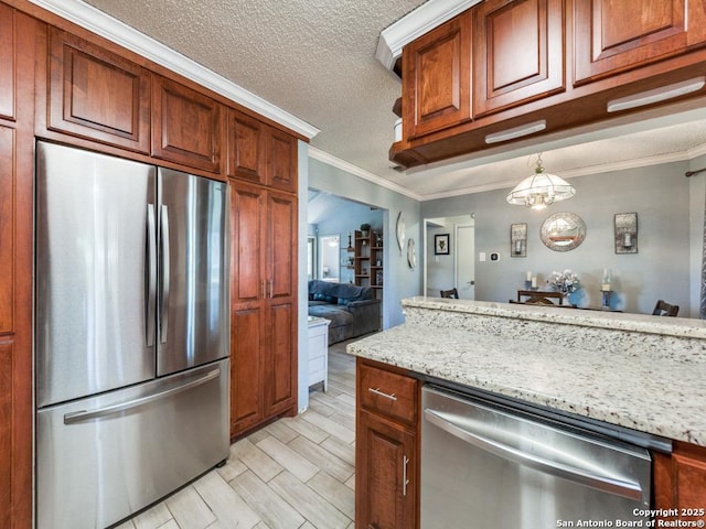 kitchen featuring crown molding, appliances with stainless steel finishes, light stone counters, and a textured ceiling