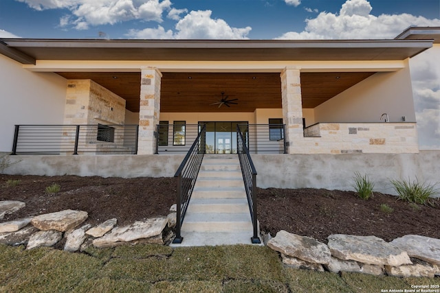 view of exterior entry with ceiling fan