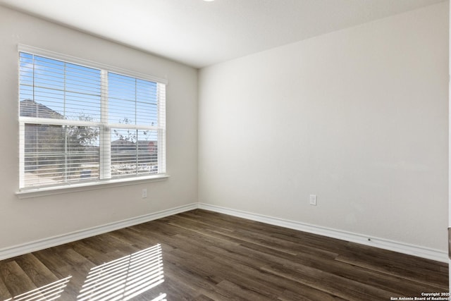 spare room with dark hardwood / wood-style floors