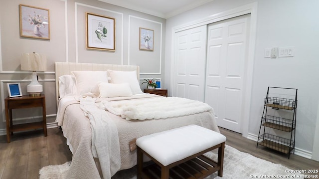 bedroom with ornamental molding, dark hardwood / wood-style flooring, and a closet