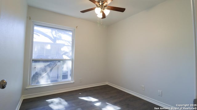 empty room featuring dark hardwood / wood-style flooring and ceiling fan