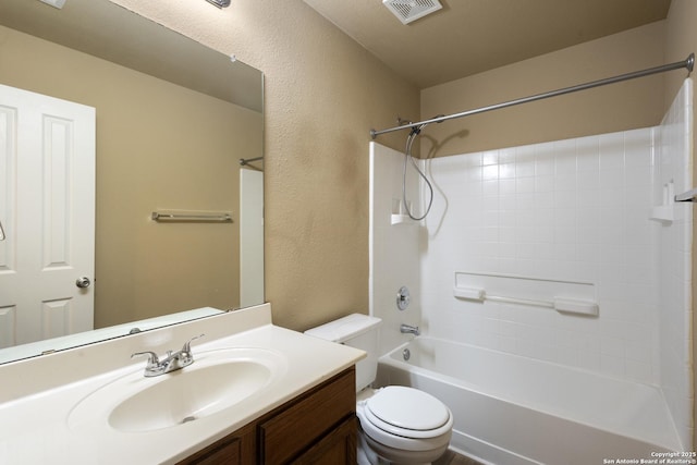 bathroom featuring vanity, visible vents, shower / bath combination, toilet, and a textured wall