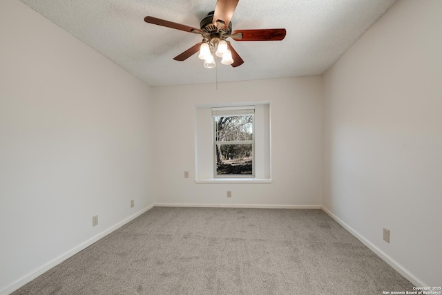 carpeted empty room with ceiling fan and a textured ceiling