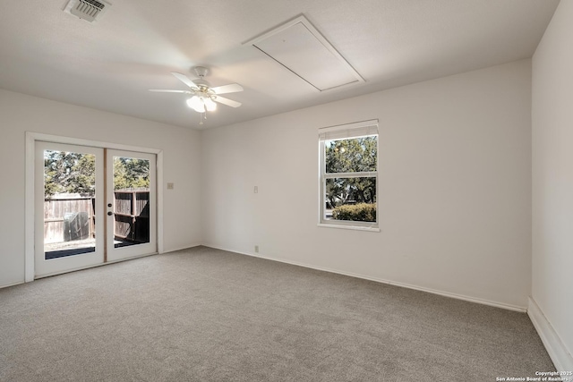 empty room featuring carpet, a wealth of natural light, and french doors