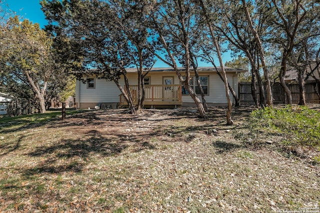 rear view of house with a yard and a deck