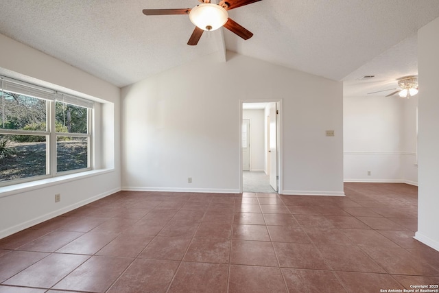 unfurnished room with tile patterned flooring, ceiling fan, lofted ceiling, and a textured ceiling