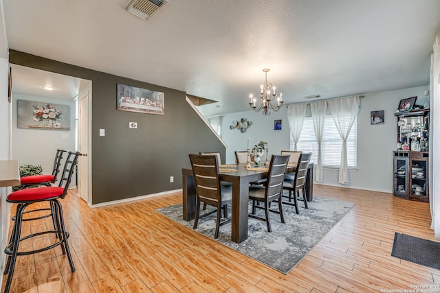 dining room featuring a chandelier and light wood-type flooring