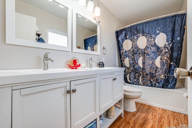 full bathroom with vanity, wood-type flooring, shower / tub combo, and toilet