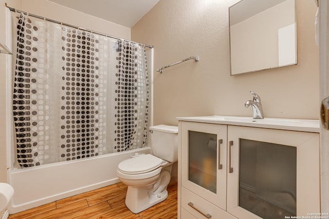 full bathroom featuring hardwood / wood-style flooring, vanity, toilet, and shower / bath combo