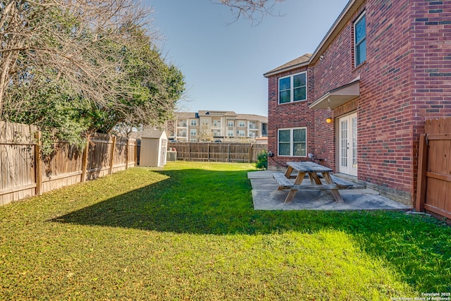 view of yard featuring a patio and a storage shed