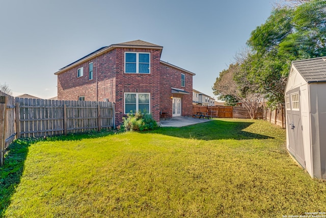 view of yard featuring a shed and a patio