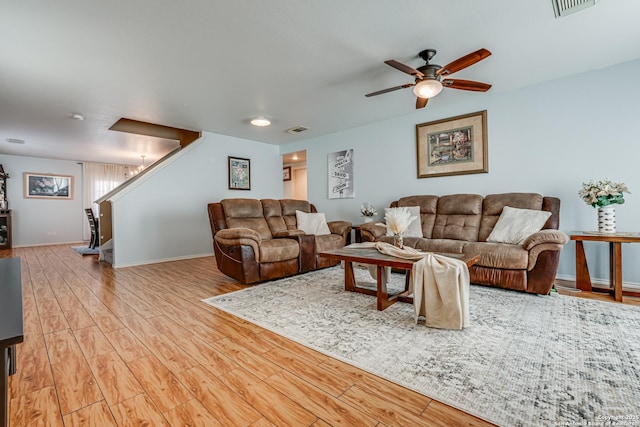 living room with ceiling fan and light wood-type flooring