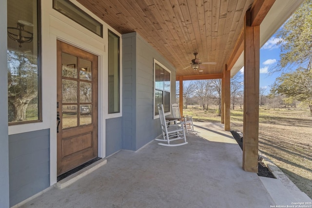 view of patio with ceiling fan and a porch