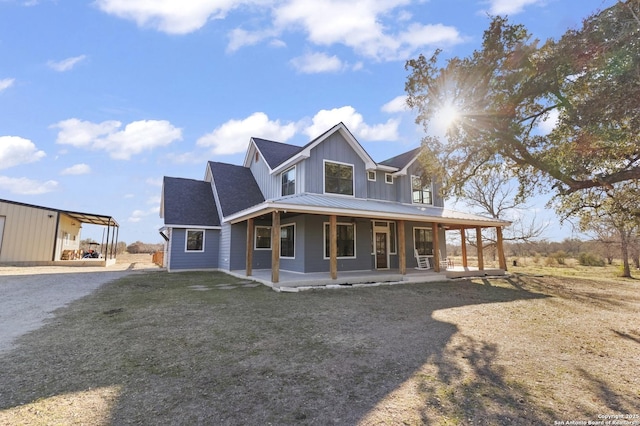 farmhouse-style home with a porch and a front lawn