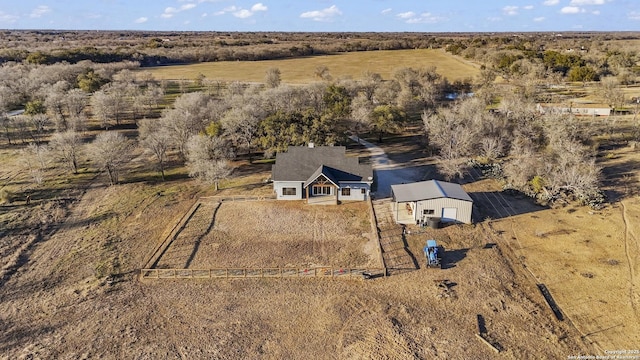 birds eye view of property with a rural view