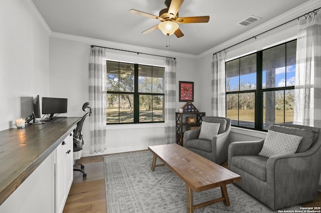 home office with hardwood / wood-style flooring, ceiling fan, crown molding, and a wealth of natural light