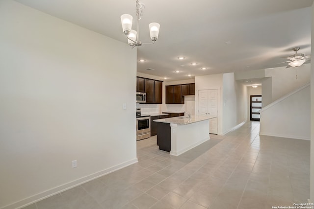 kitchen featuring light tile patterned flooring, appliances with stainless steel finishes, sink, and a kitchen island