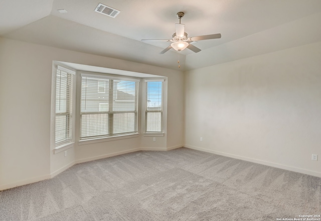 carpeted spare room with ceiling fan and lofted ceiling