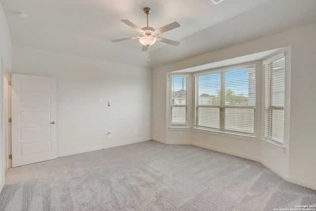 carpeted spare room with lofted ceiling and ceiling fan