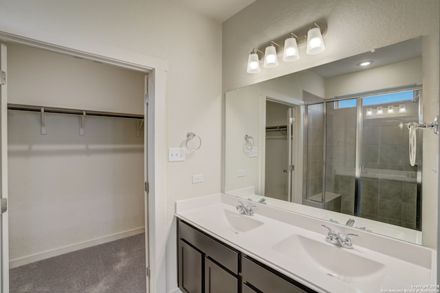 bathroom with vanity and a shower with shower door