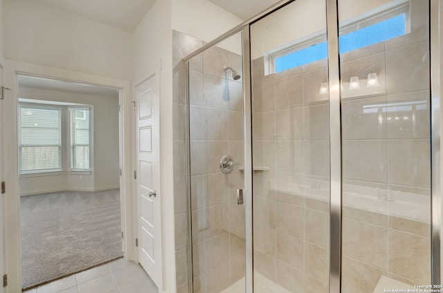 bathroom with tile patterned flooring and a shower with shower door