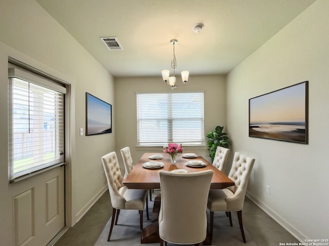 dining space featuring a healthy amount of sunlight and a notable chandelier