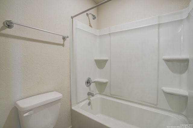 bathroom with bathtub / shower combination and toilet