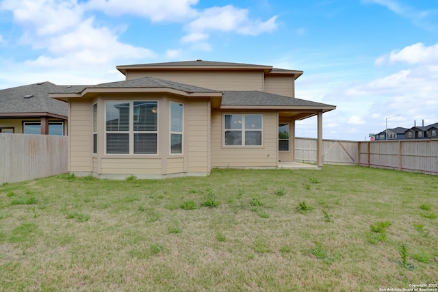 back of property featuring a yard