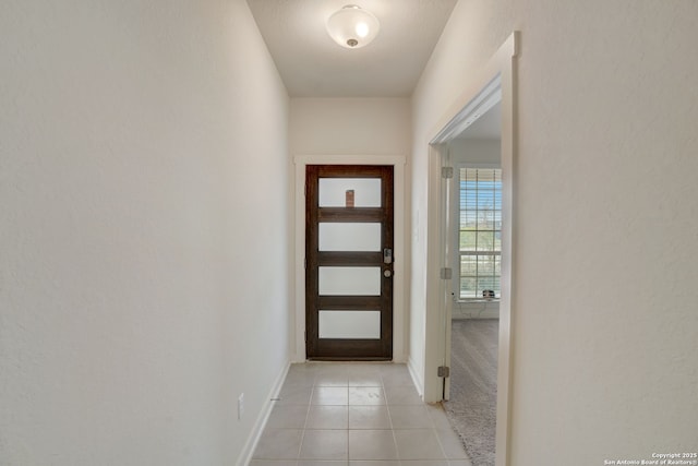 doorway to outside featuring light tile patterned floors