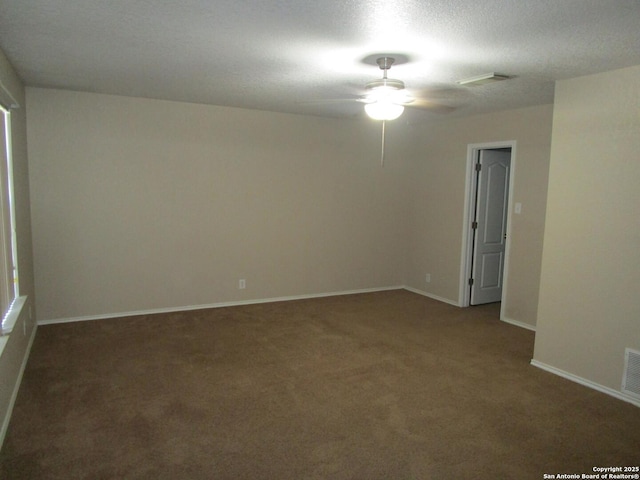 carpeted spare room with a textured ceiling and ceiling fan