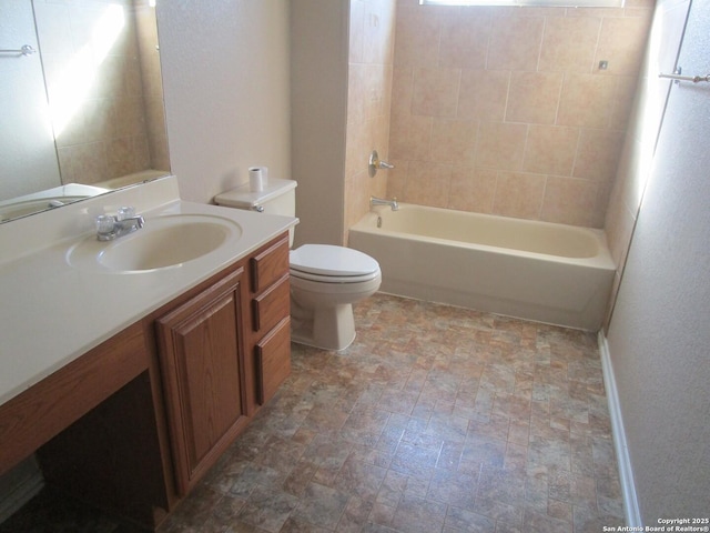 full bathroom featuring tiled shower / bath combo, vanity, and toilet