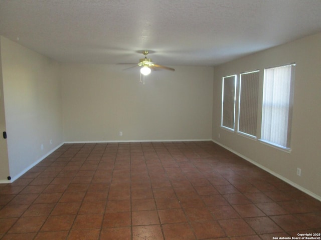 tiled empty room with ceiling fan