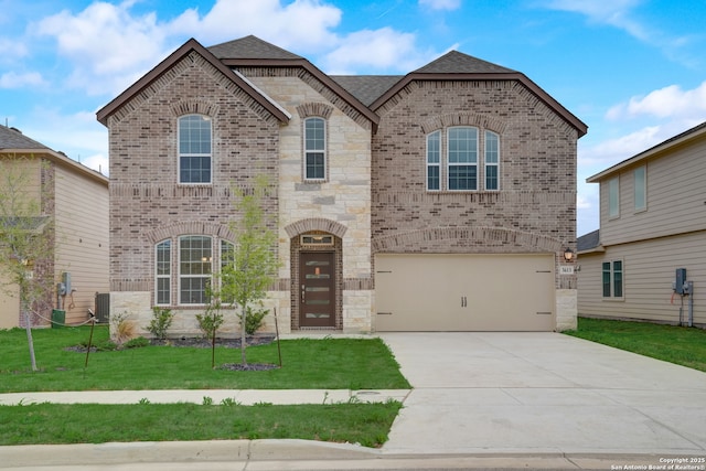 view of front of property featuring a garage, cooling unit, and a front yard