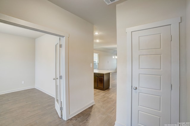 corridor featuring light hardwood / wood-style flooring