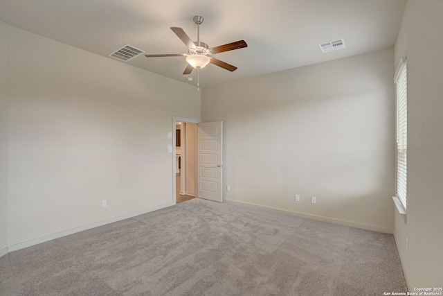 carpeted empty room featuring ceiling fan and a healthy amount of sunlight