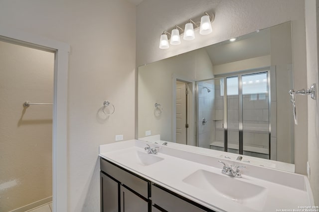 bathroom with a shower with door and vanity