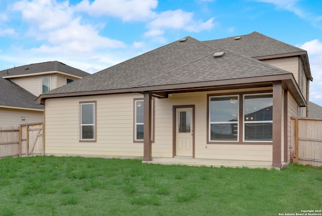 rear view of property featuring a lawn