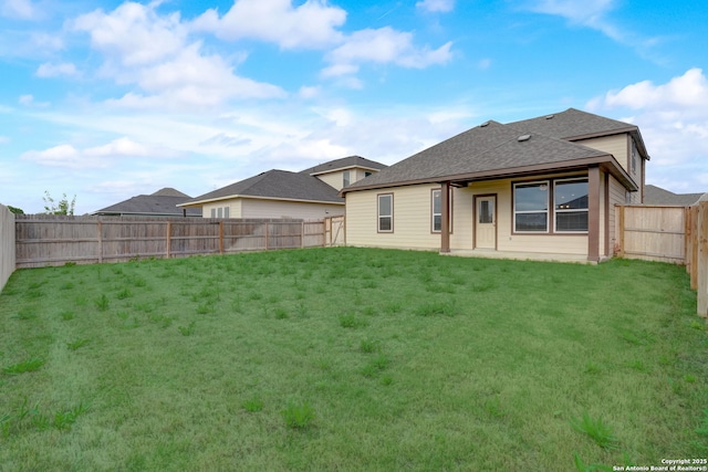 rear view of property with a yard