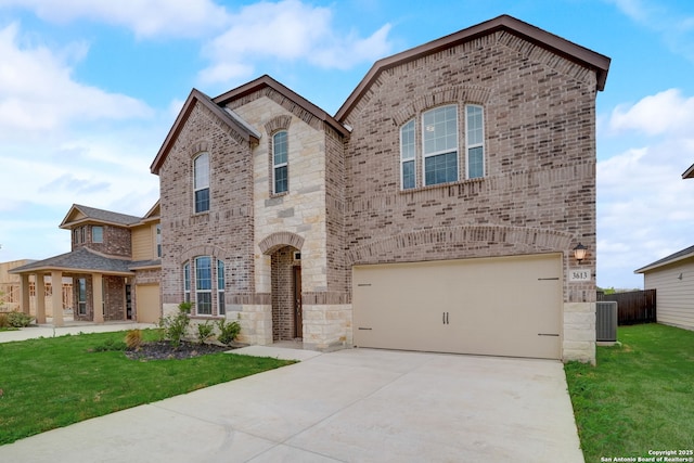 view of front of house with a garage, a front yard, and central air condition unit