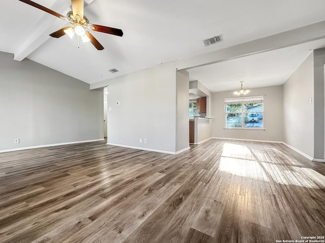 unfurnished living room with ceiling fan with notable chandelier, hardwood / wood-style floors, and lofted ceiling with beams