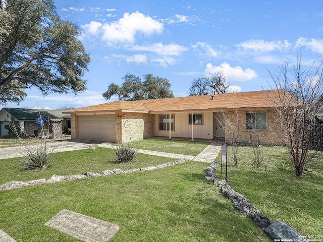 single story home with a garage, driveway, a front lawn, and brick siding